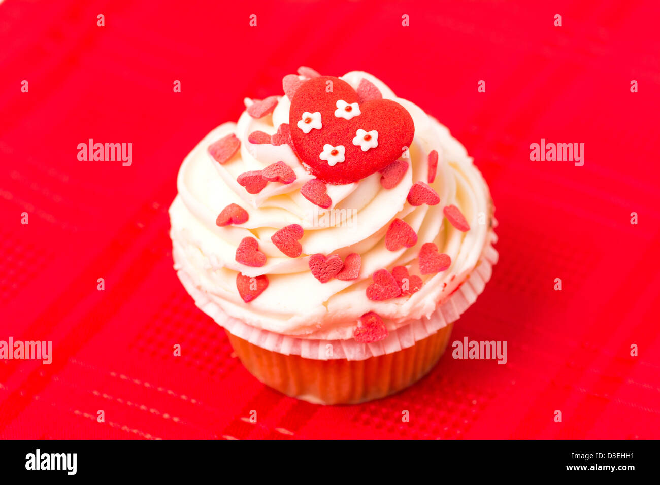 Tasse Kuchen verziert mit Liebe und Herz unter dem Motto Design - rotem Hintergrund Stockfoto