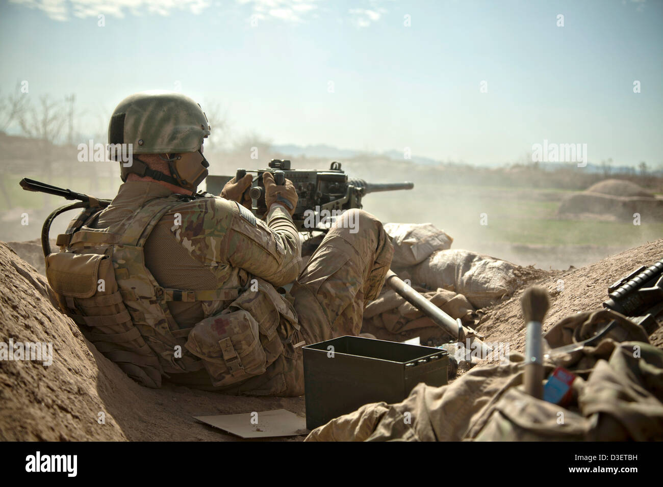 Ein US-Marine wacht mit einem schweren Maschinengewehr als Afghan National Army Special Forces Soldaten aus einem Kampf Patrouille zurück 17. Februar 2013 in der Provinz Herat, Afghanistan. Präsident Barack Obama kündigte während der Staat der Union, dass die Hälfte die US-Force in Afghanistan von Anfang 2014 zurückziehen wird. Stockfoto