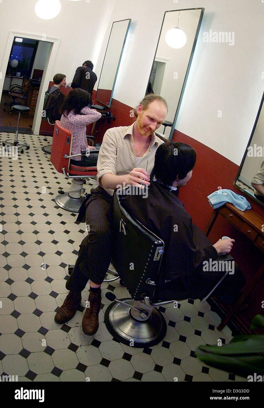 (Dpa) - Friseur Deedee schneidet ein Kunde Haare beim Friseur Shop "Dein Friseur ist Nicht Dein zitierter" (Ihre Frisur ist nicht dein Feind) in Frankfurt am Main, 14. Februar 2003. Die lähmende Wirtschaft macht ihre Haare ausreißen Coiffeurs: für das Jahr 2002 die Friseure erwarten einen Rückgang von minus 4 Prozent für Männer Friseure und minus 2,3 Prozent für Frauen Coiffeurs. Es ist nicht nur Stockfoto