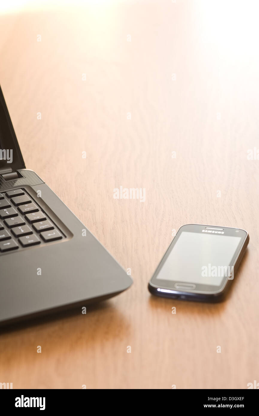 Laptop und Handy auf einen Schreibtisch. Stockfoto