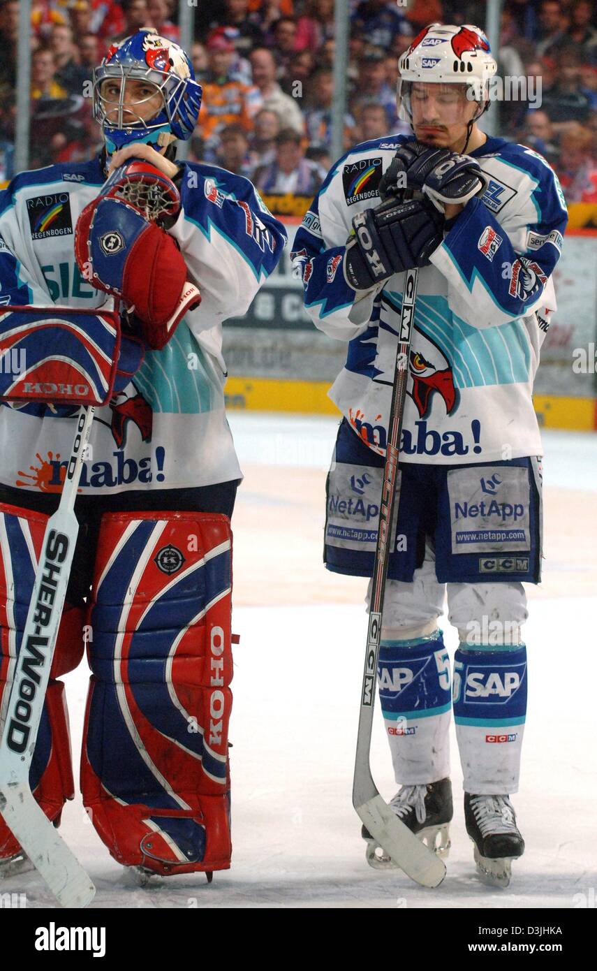 (Dpa) - die Mannheimer Jochen Hecht (R) Kapitän und Torhüter Cristobal Huet (L) suchen enttäuscht, nachdem ihr Team der deutschen Eishockeyliga-Match zwischen Eisbaeren Berlin und die Adler Mannheim in Berlin, 15. April 2005 verloren. Mannheim verloren: 1-4 gegen Berlin gewonnen die beiden vorherigen Spiele in die Play-off-Finals-Serie unter den deutschen Eishockey-Weltmeister-Titel. Stockfoto