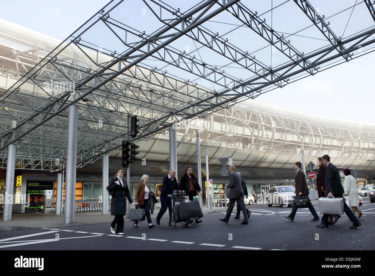 (Dpa) - Reisende mit Gepäck im Bild vor dem Flughafen-terminal in Düsseldorf, 16. März 2005. Stockfoto