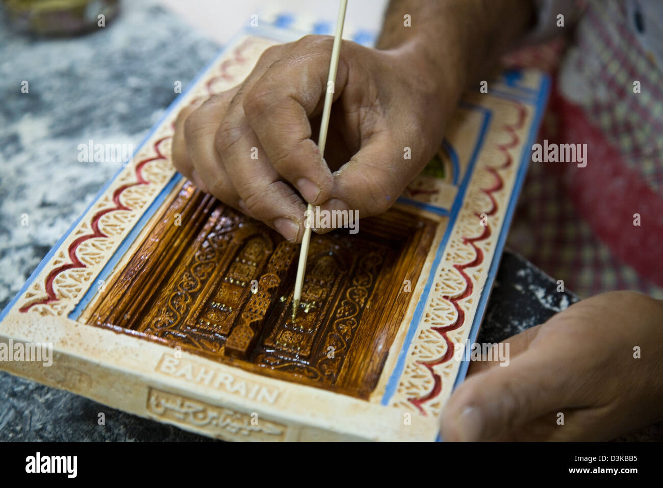 Diese Handwerker graviert und malt Gips-Platten bei Al-Jasara Handwerkszentrum in Manama, Bahrain. Stockfoto