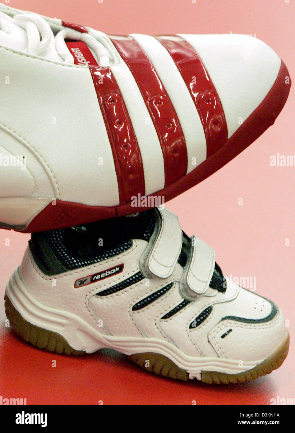 Dpa) - das Bild zeigt eine Adidas Basketballsneaker auf einem Reebok Baby  Sneaker in ein Sportgeschäft in Frankfurt Main, Deutschland, Mittwoch, 3.  August 2005. Um die Lücke zu weltweit führenden Sportartikel erwarb