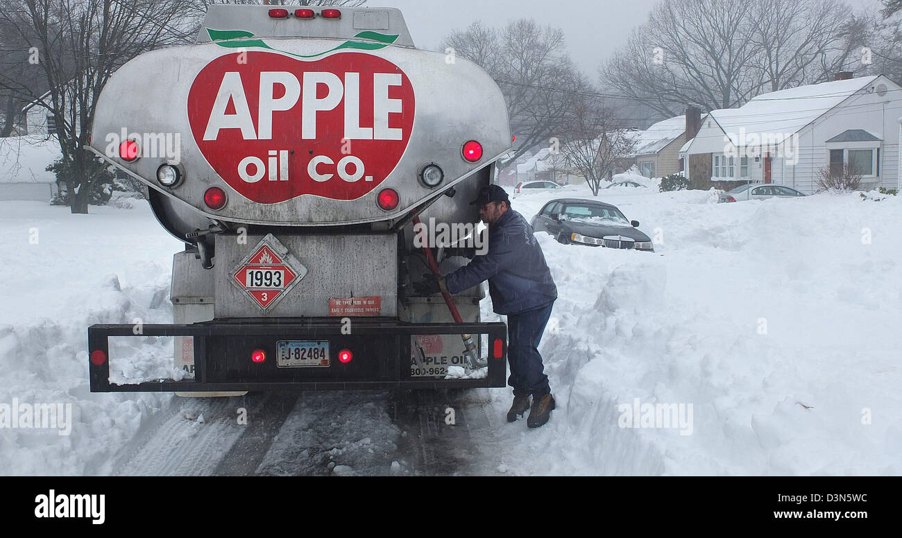 New Haven, CT USA An Apple Öl Fahrer macht eine Lieferung auf Marlin Laufwerk im strömenden Regen nach einem Sturm. Winter in Connecticut Stockfoto