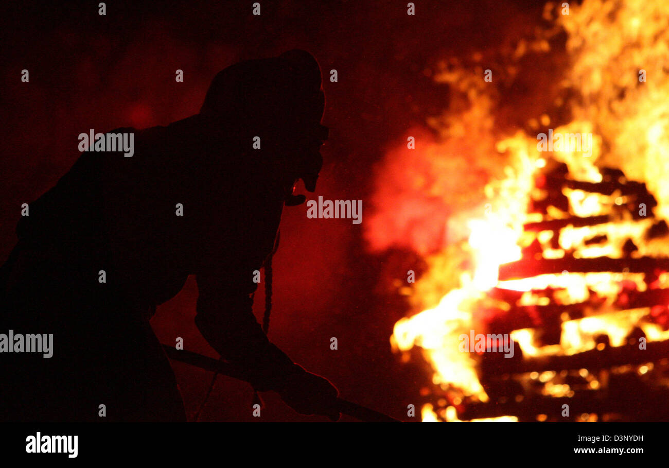 Eine Hexe tanzt um ein Feuer auf die traditionellen Hexen Sabbat auf dem Marktplatz in Waldkirch, Deutschland, Samstag, 25. Februar 2006. Die jährliche ver÷ffentlicht findet Ort o am Samstag vor Karneval Montag. Foto: Patrick Seeger Stockfoto