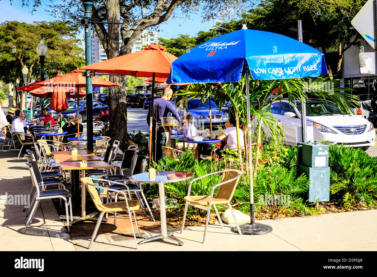 Stühle und Tische vor einem Restaurant an der Hauptstraße in Sarasota Florida Stockfoto