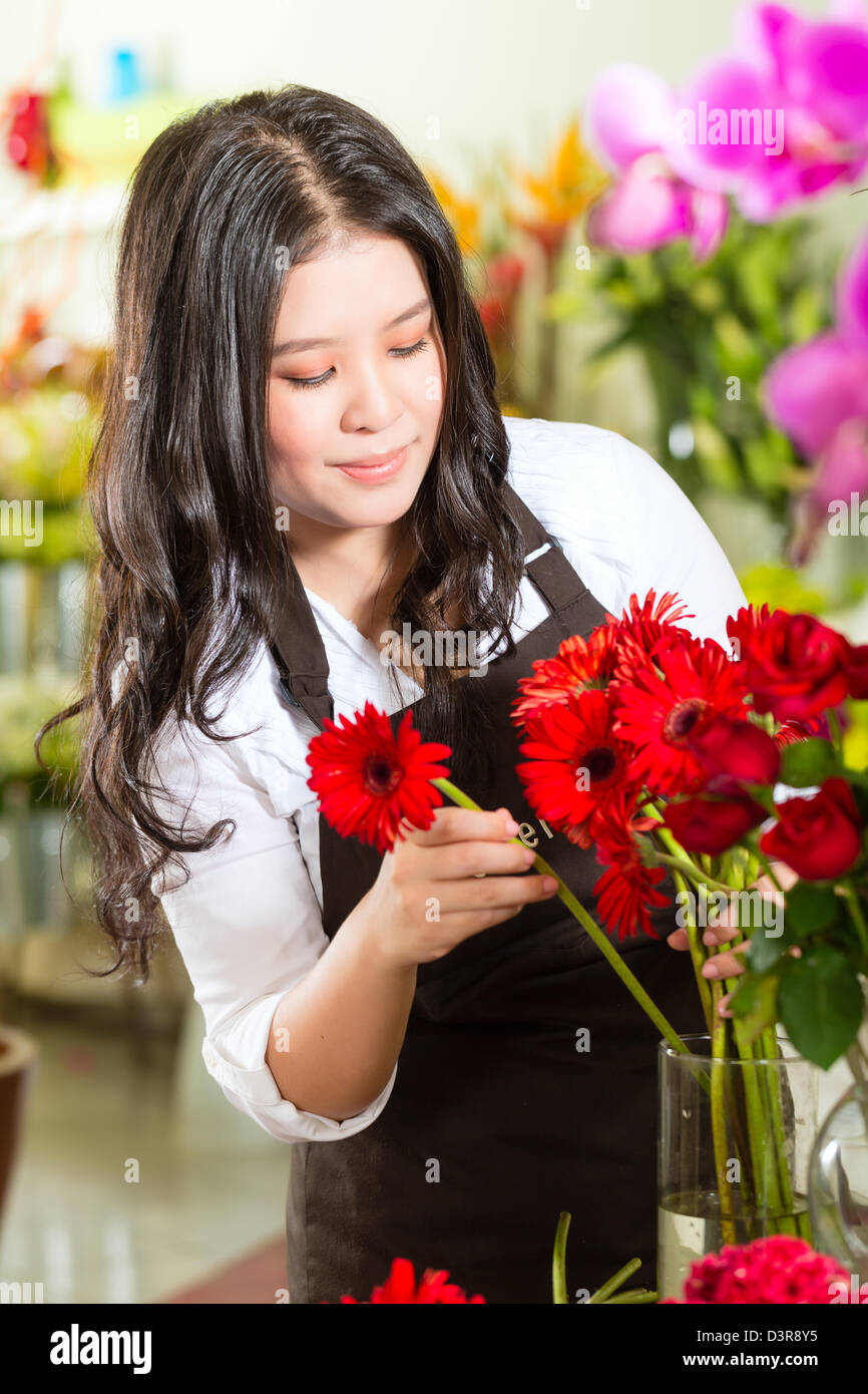 Freundliche asiatische Floristin oder Verkäuferin in einem Blumenladen Stockfoto