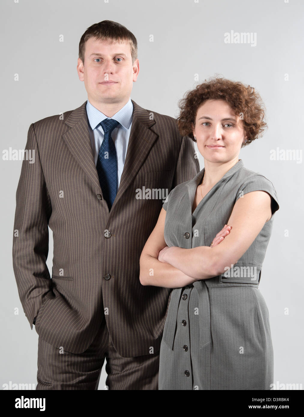 Junges Unternehmen paar, Geschäftsmann und Geschäftsfrau in grauen Anzügen Stockfoto