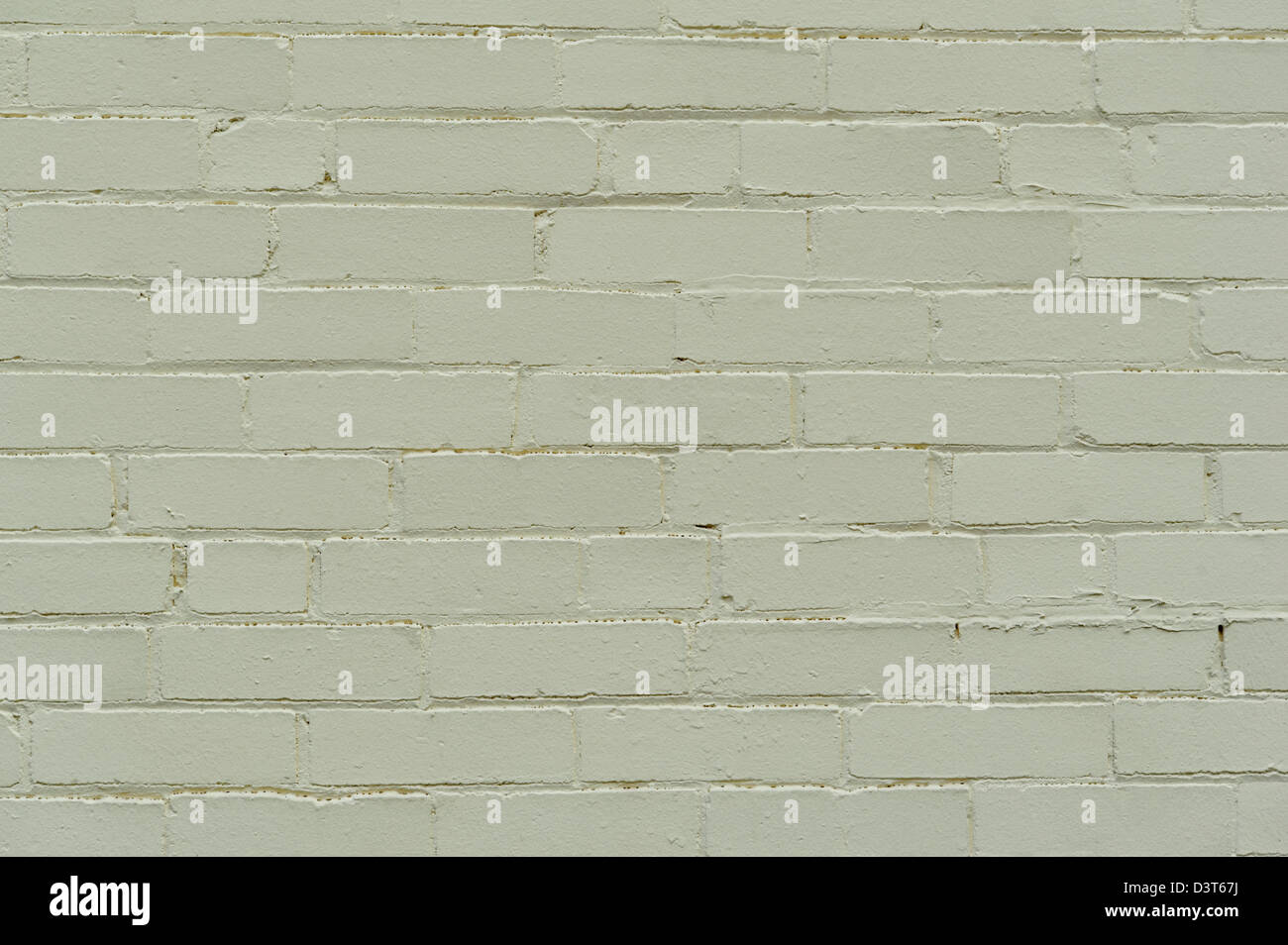 Gemauerte Wand in Salbeigrün mit glatten Mörtelfugen, Hintergrund-Design-Element. Stockfoto