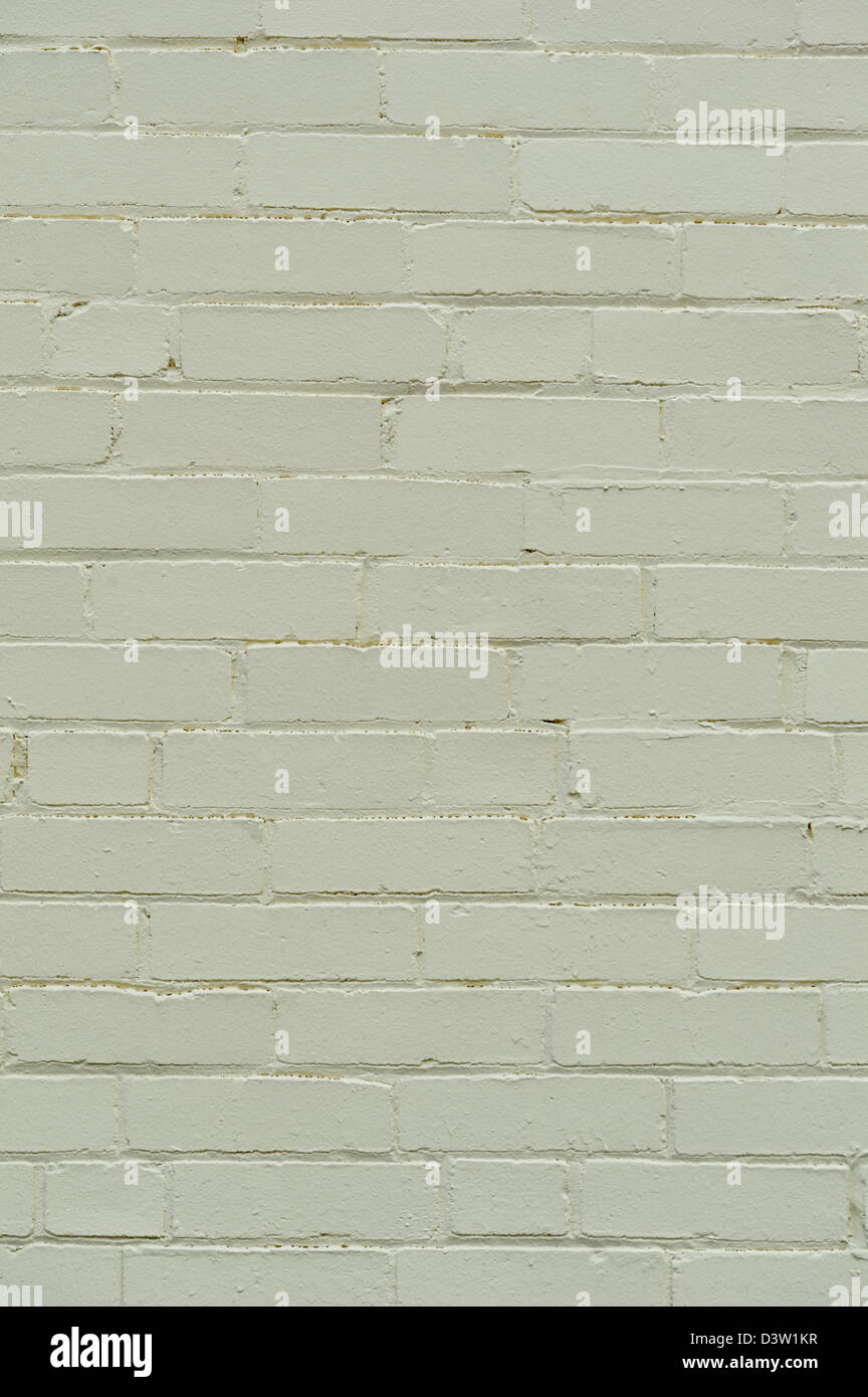Gemauerte Wand in Salbeigrün mit glatten Mörtelfugen, Hintergrund-Design-Element. Stockfoto