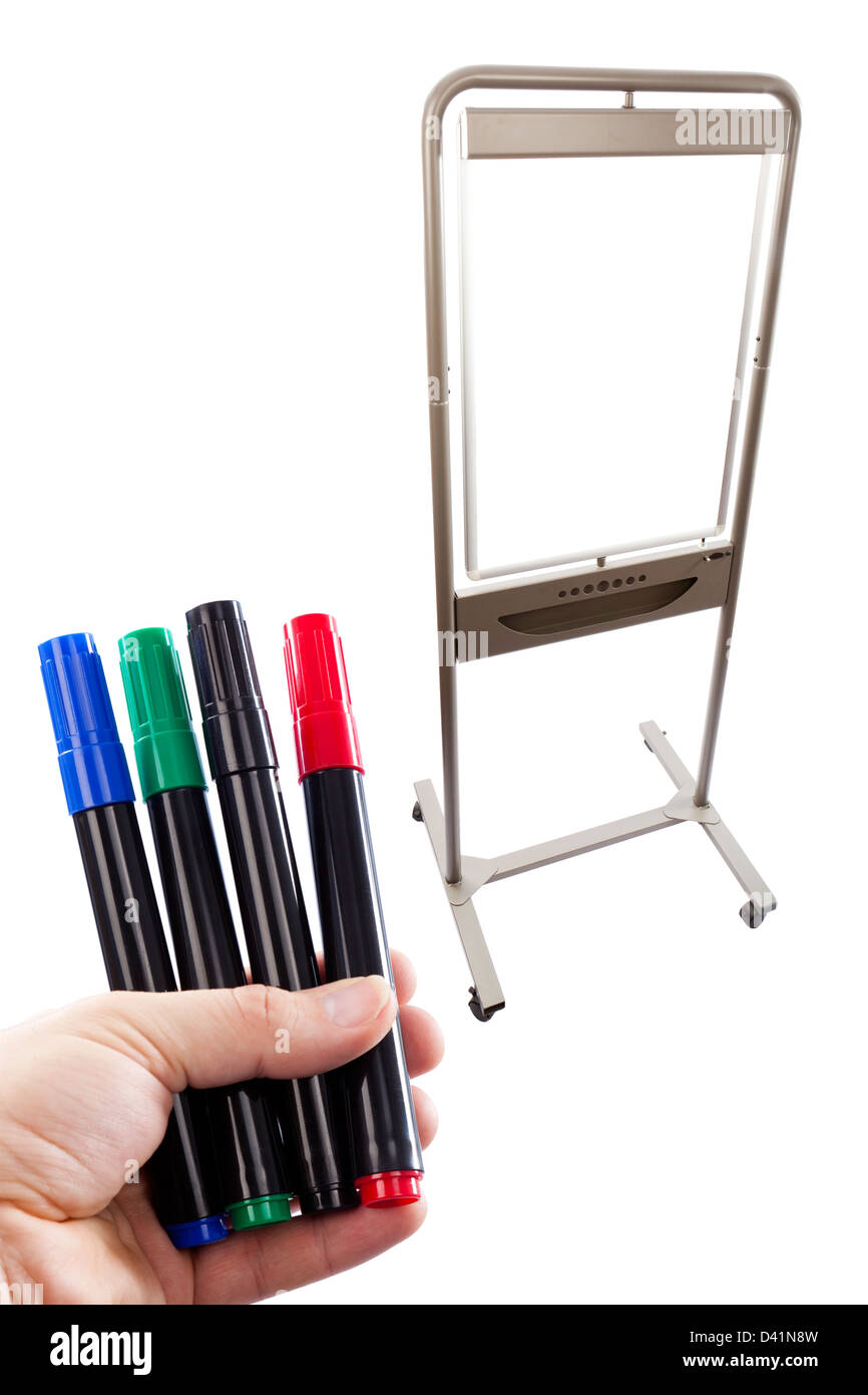Multi farbige Stifte hielt vor einem Flip-Chart, kombiniert in der Postproduktion auf weißem Hintergrund. Stockfoto