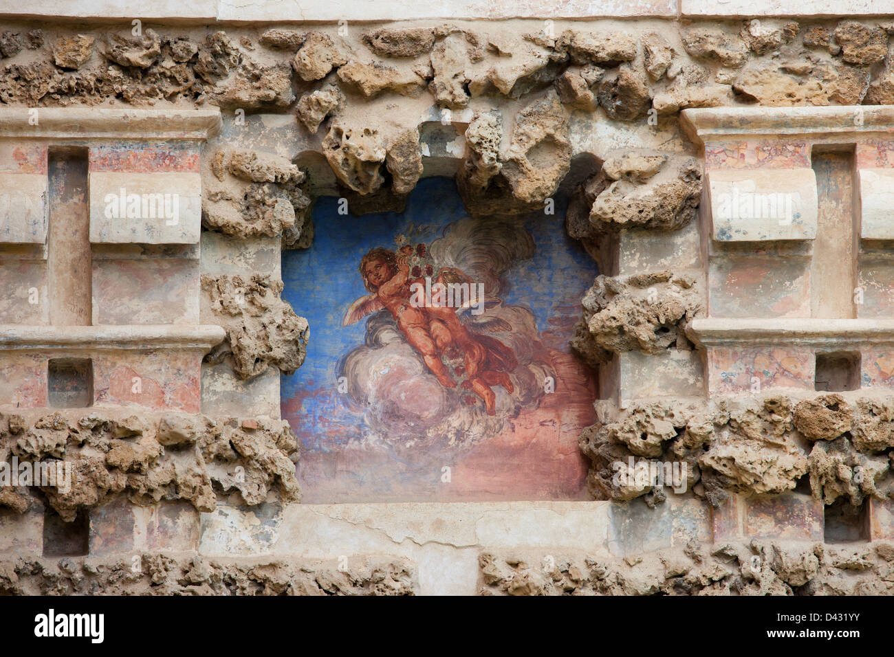 Engelchen auf einer alten Nische Fresko der grotesken Galerie in Real Alcazar Garten der Teich, Sevilla, Andalusien, Spanien. Stockfoto