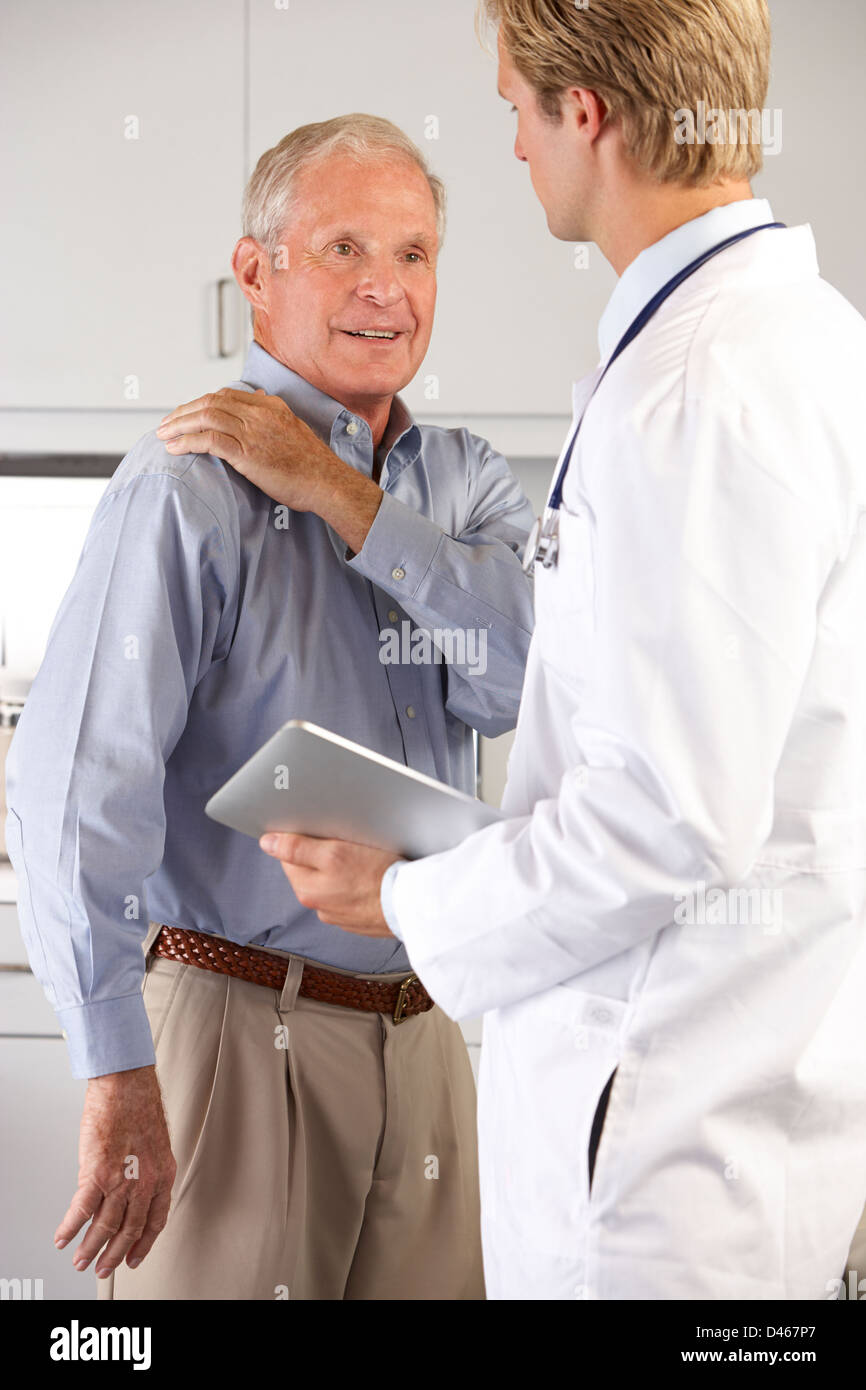 Arzt untersucht männlichen Patienten mit Schmerzen in der Schulter Stockfoto