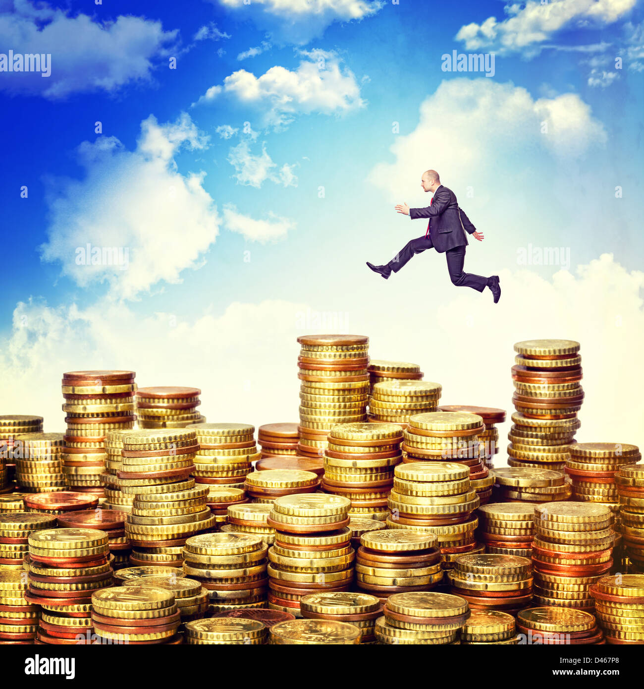 Geschäftsmann springen über Euro Münze Pfähle Stockfoto