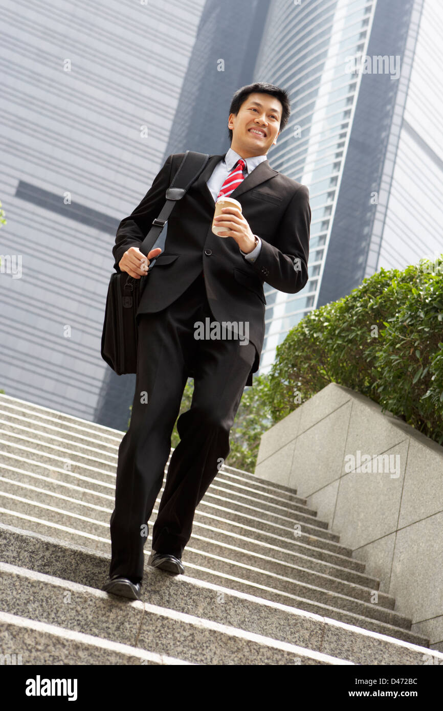 Chinesischer Geschäftsmann hetzen, Treppenstufen, Tragetasche und Kaffee zum mitnehmen Stockfoto