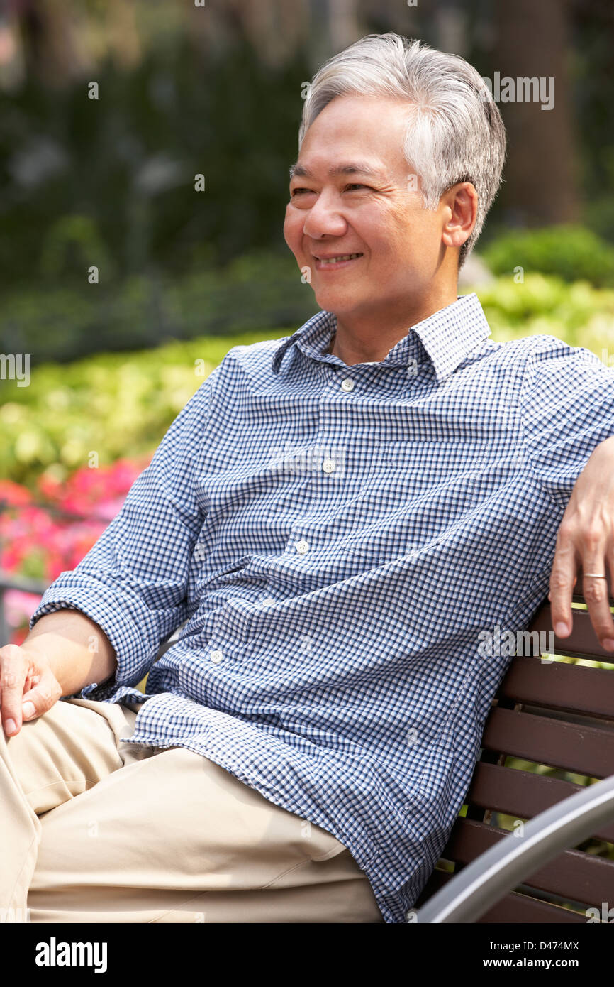 Senior chinesischer Mann auf der Parkbank Stockfoto