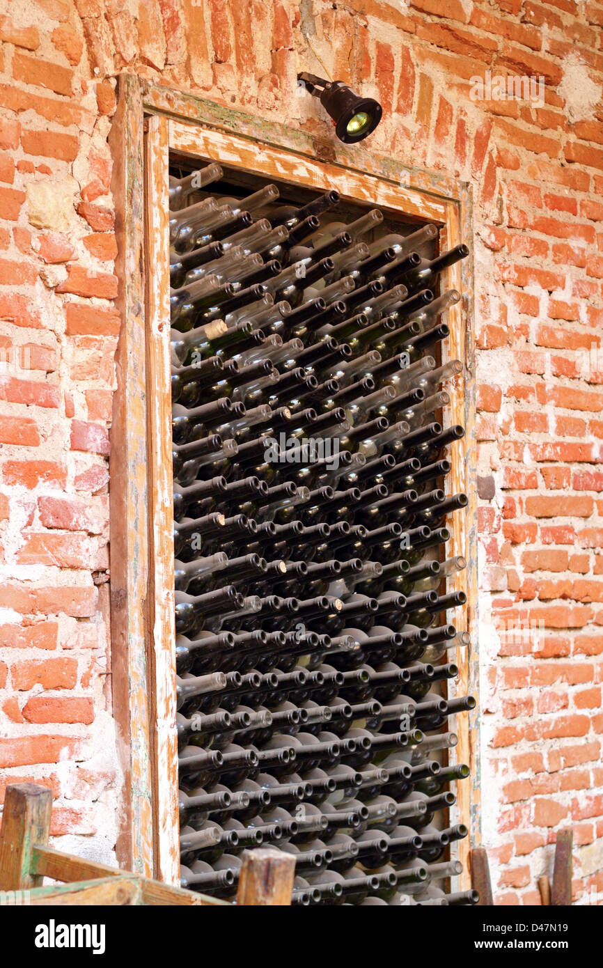 alte Weinflaschen links in einer Nische an der Wand Stockfoto