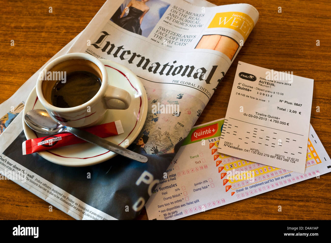 Morgendliche Tasse Kaffee, Wetten rutscht und International Herald Tribune Zeitung - Frankreich. Stockfoto