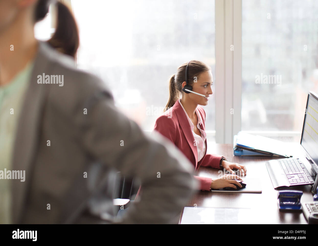 Geschäftsfrau tragen Kopfhörer am Schreibtisch Stockfoto