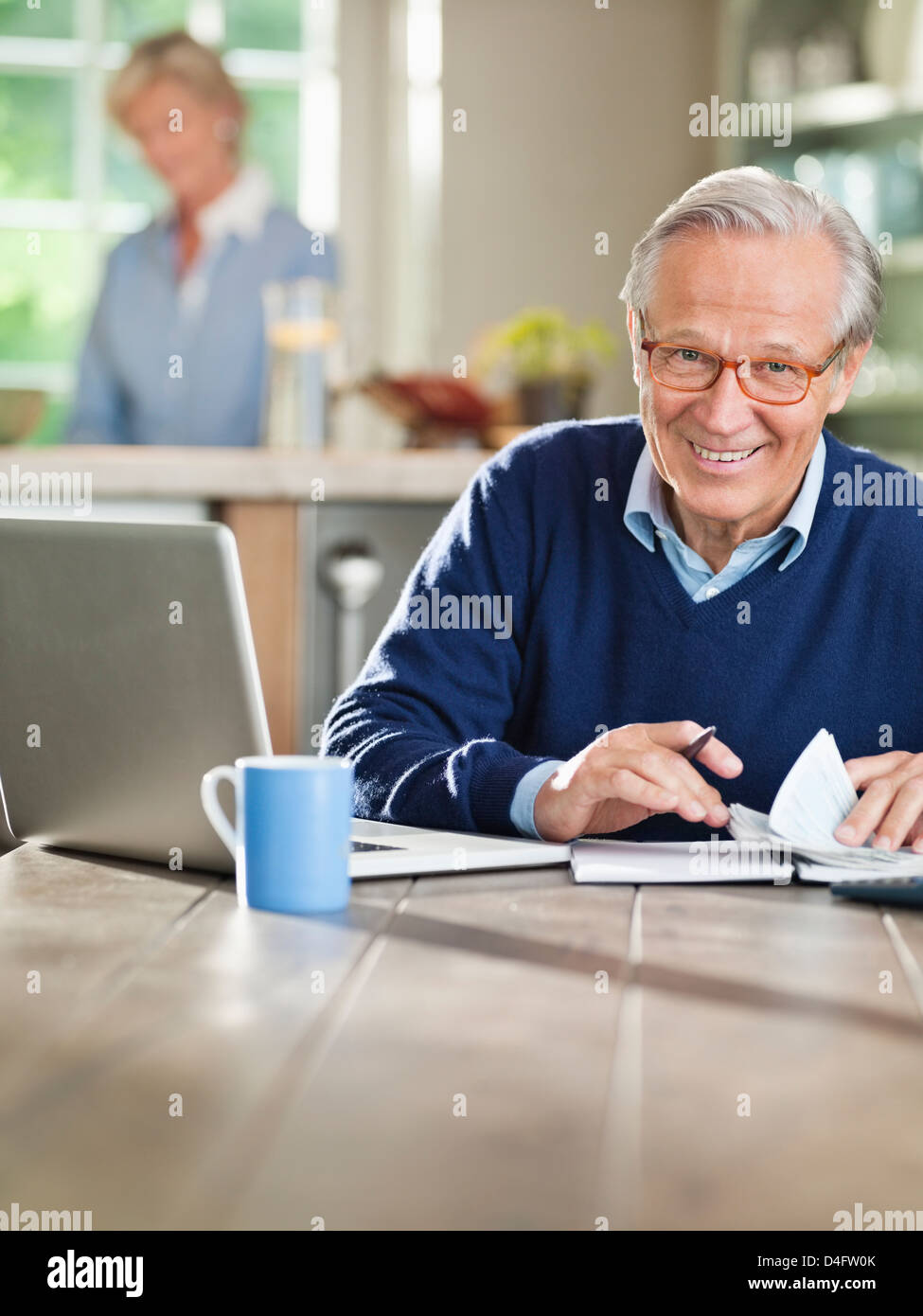 Mann mit Laptop am Küchentisch Stockfoto