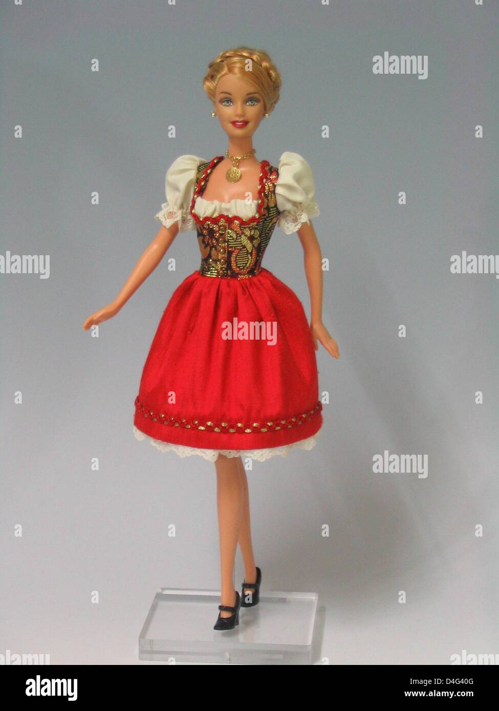 Das undatierte Handhout zeigt eine Barbie-Puppe gekleidet in eine deutsche Tracht, ein "Dirndl" durch Kanalisation Eva Baierl, in München. Das diesjährige Oktoberfest-Modell besteht aus Seide Brokat, Spitze, Gold und rot. Baierl hat bereits etwa 30 Kleider für Puppen, aus schwarz und grau Taft oder Spitze, während andere nur einfache pastellfarbene Blume Kleider entworfen. Foto: Redaktio Stockfoto