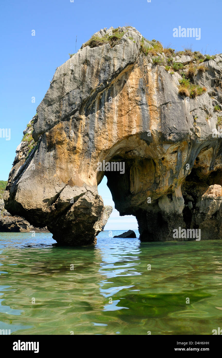 Naturstein-Torbogen geschnitzt am Meer durch Kalkfelsen im Cuevas del Mar (Meereshöhlen) Strand, in der Nähe von Llanes, Asturien, Spanien Stockfoto