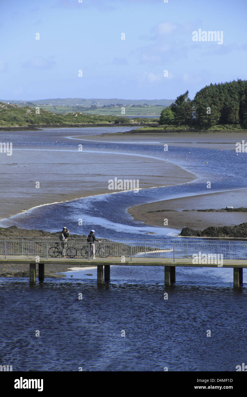 Zwei Radfahrer auf einer Brücke über die Mündung des Flusses bawnaknockane in der Nähe von Ballydehob, West Cork, Republik von Irland Stockfoto