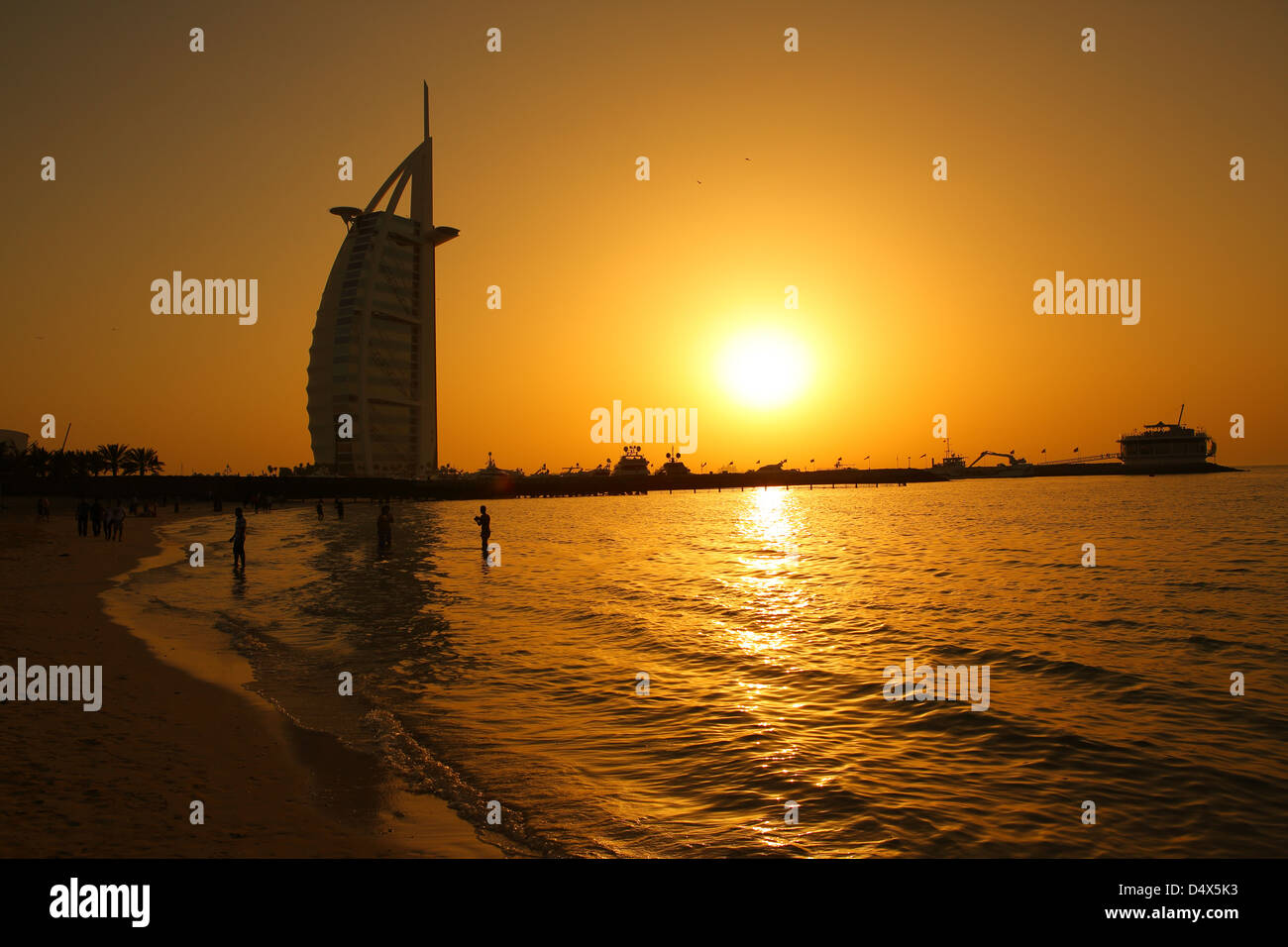 Strand von Jumeirah und Burj Al Arab Hotel bei Sonnenuntergang, Dubai, Vereinigte Arabische Emirate Stockfoto