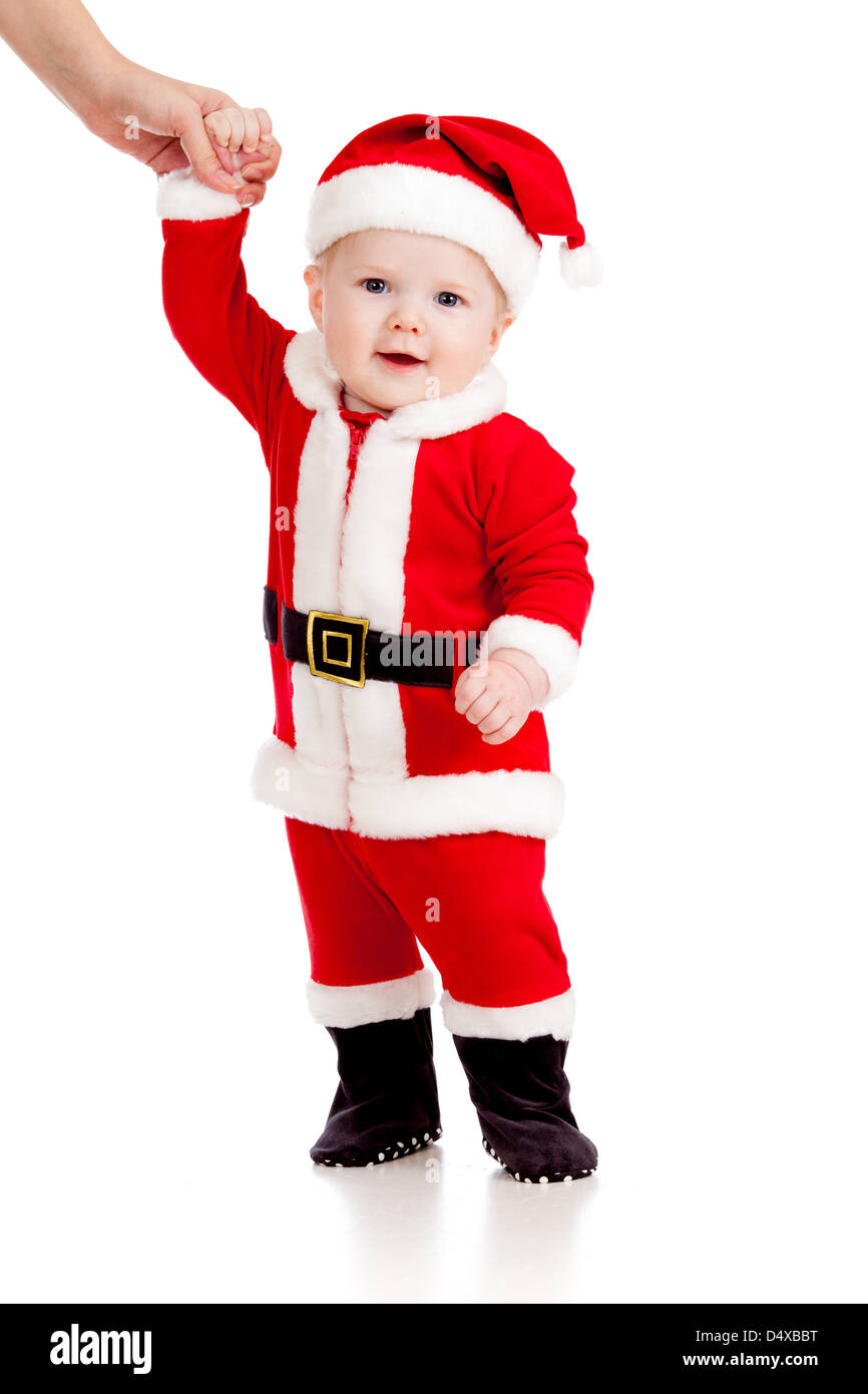 erste Schritte der niedlichen Baby als Weihnachtsmann verkleidet Stockfoto