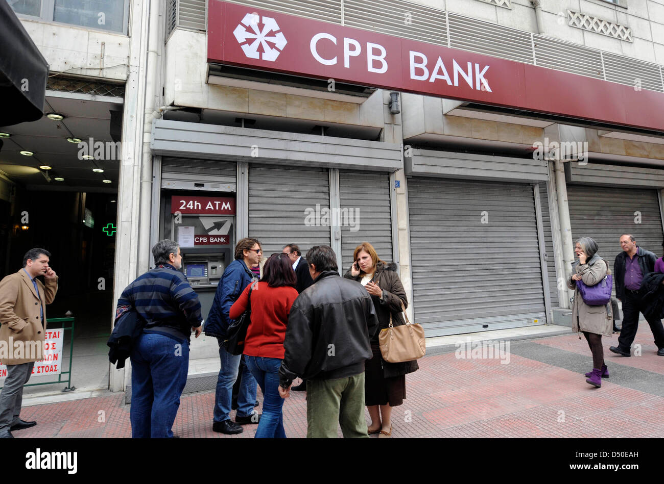 Athen, Griechenland. 21. März 2013. Leute warten vor einer geschlossenen Bankfiliale zyprischen CPB (zypriotische popular Bank), ATM, zu verwenden in Athen, Griechenland.  Bildnachweis: Kunst der Fokus / Alamy Live News Stockfoto