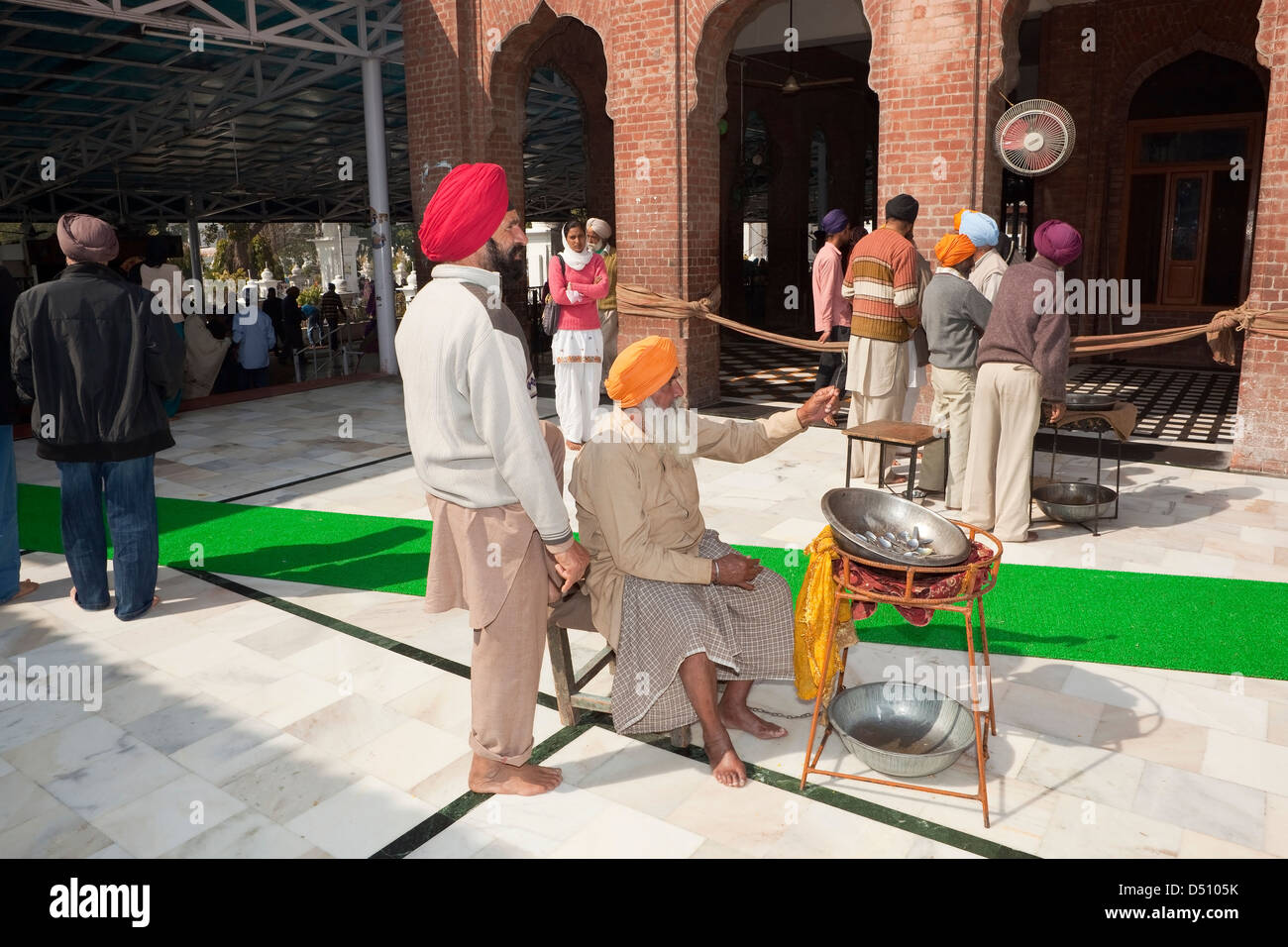 Sikh Freiwillige sammeln Besteck für Abwasch in der freien Küche innerhalb der Golden Tempel Komplex Amritsar Punjab Indiens Stockfoto