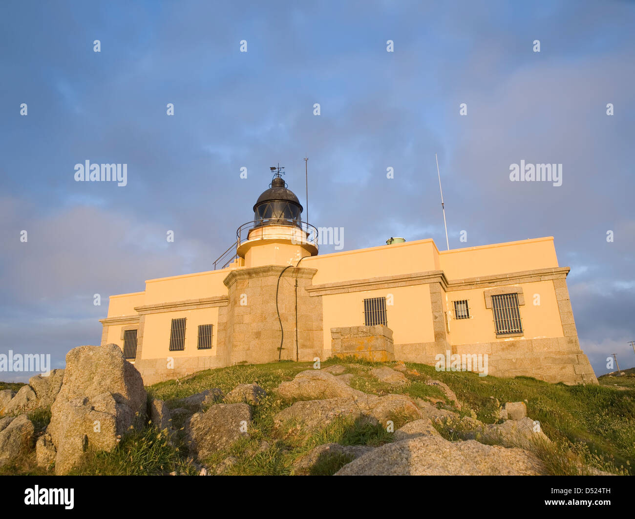 Leuchtturm, erbaut auf einem Gebäude bei Sonnenuntergang. Leuchtturm, erbaut auf einem Gebäude bei Sonnenuntergang. Der Leuchtturm im Abendlicht getaucht ist eine Stockfoto