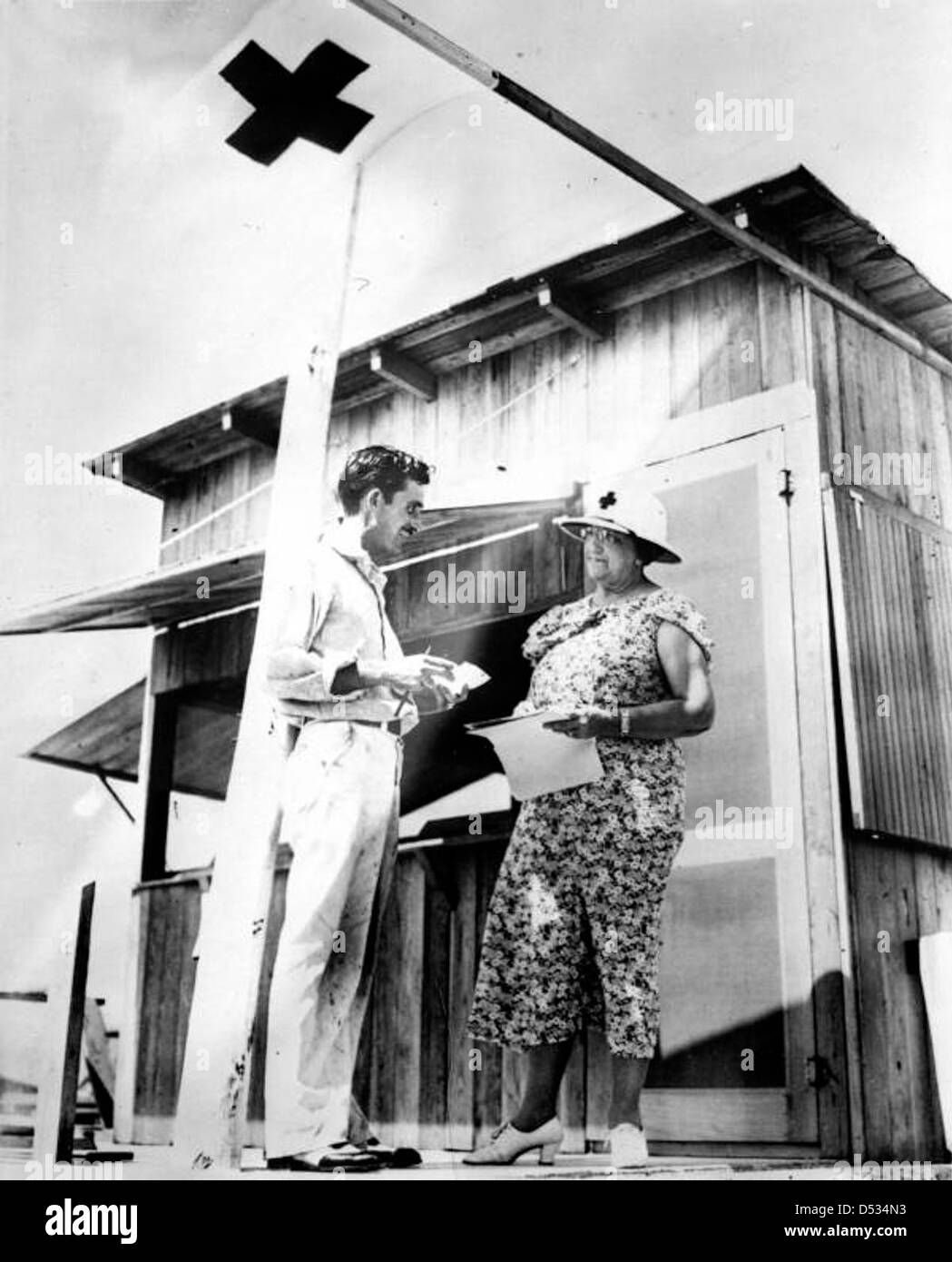 Nach dem verheerenden Hurrikan von 1935 wird Mrs. Bishop gesehen, wie er sich mit einem Mitarbeiter des Roten Kreuzes über die Pläne für den Wiederaufbau berät. Das Bild spiegelt die Erholungsbemühungen in Florida nach einem der zerstörerischsten Hurrikane in der Geschichte des Bundesstaates wider. Stockfoto