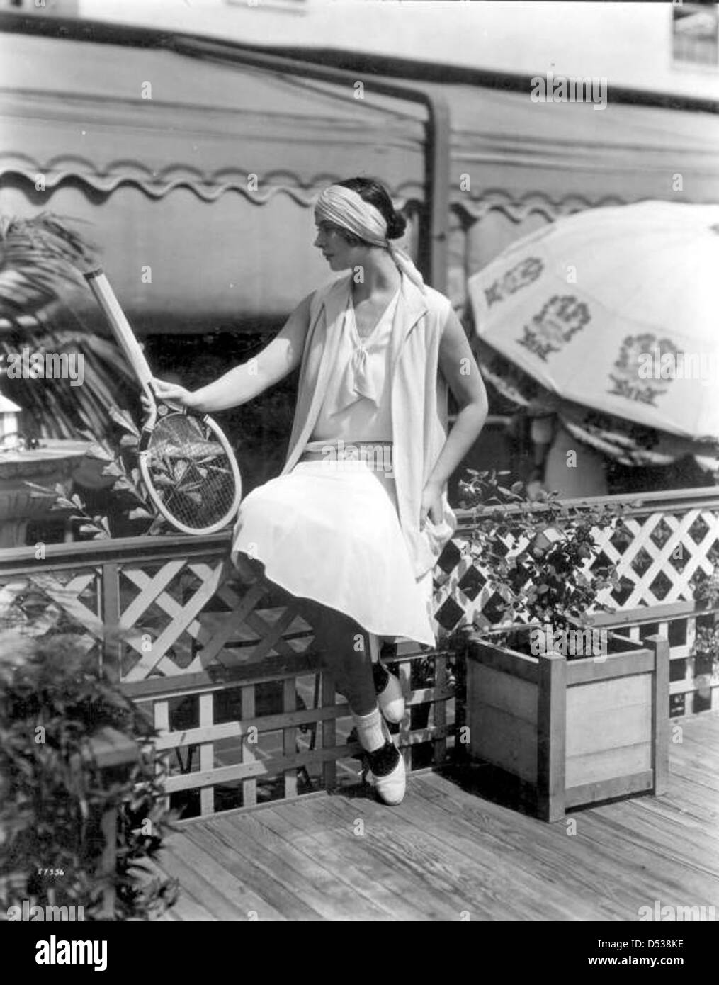 Eine Frau modelliert Tennismode vor Burdines Kaufhaus in Miami, Florida. Dieses Bild aus den 1950er Jahren unterstreicht Miamis Rolle als Modezentrum in dieser Zeit. Stockfoto