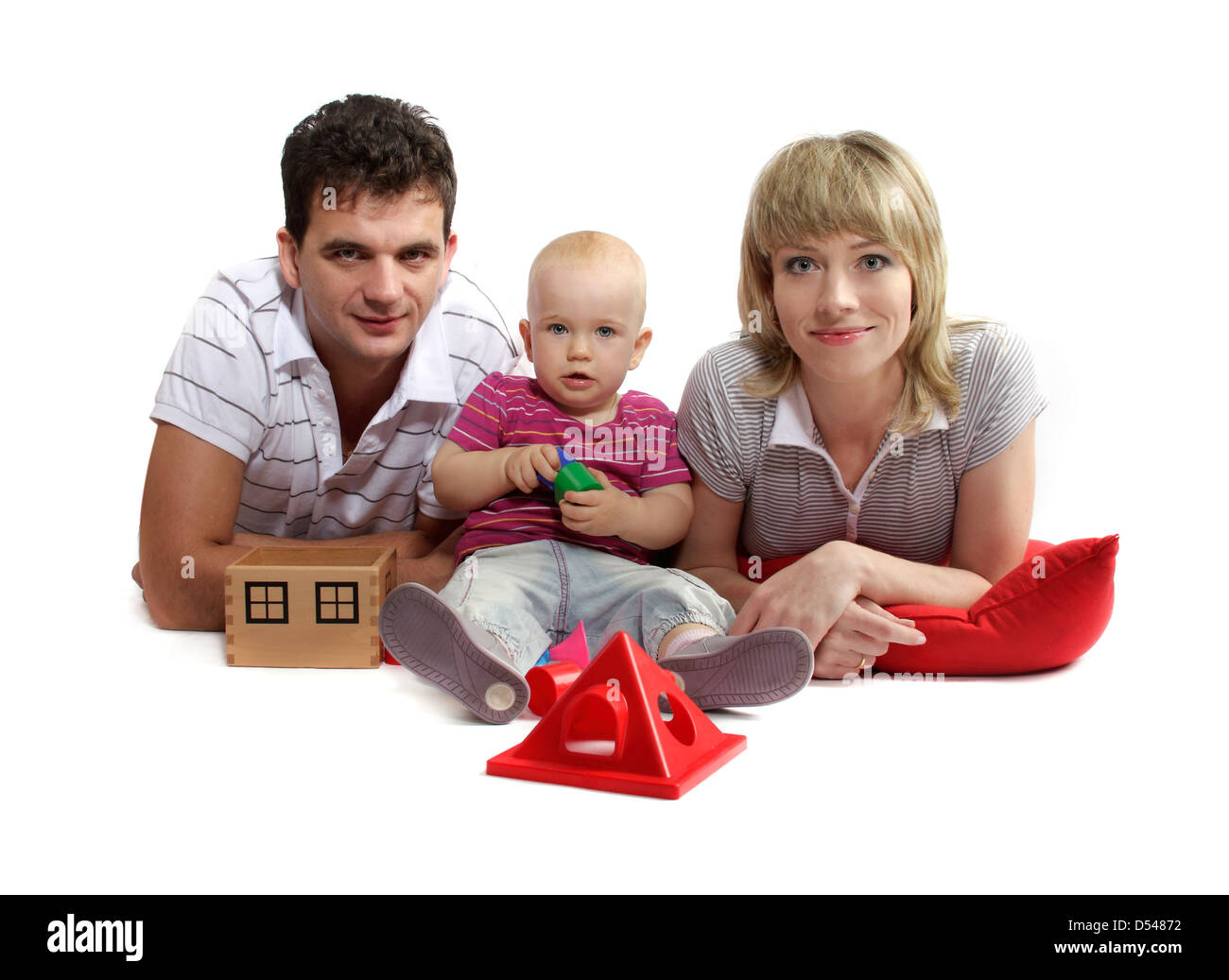 glückliche junge Familie auf dem Boden auf rote Kissen, weißer Hintergrund, Studio, isoliert Stockfoto