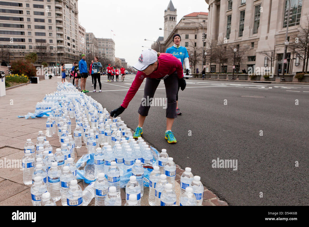 Läufer, die Abholung in Flaschen abgefülltes Wasser nach dem Rennen Stockfoto