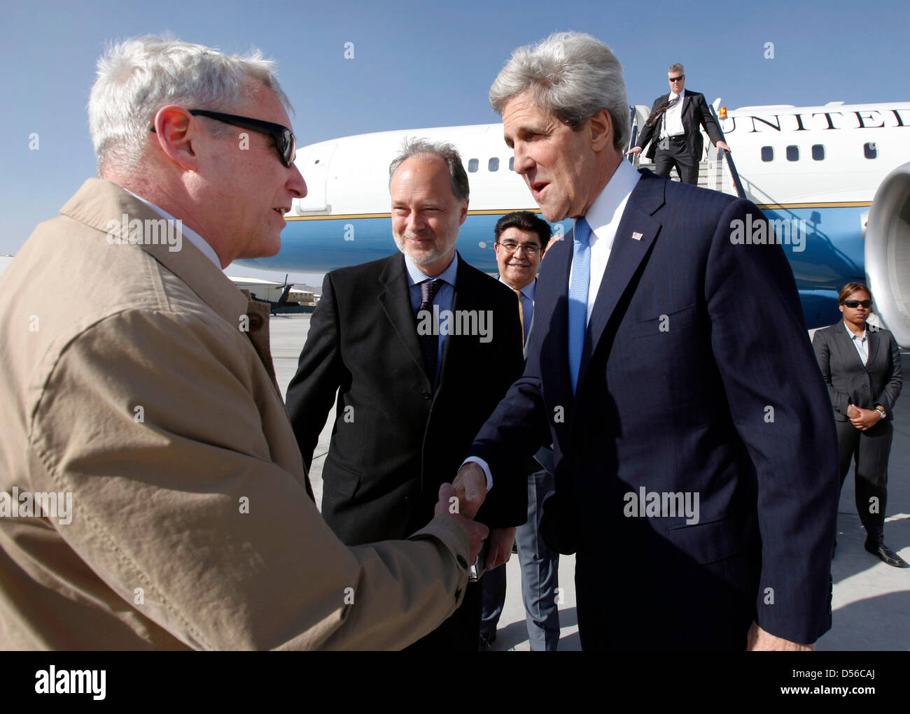 US-Außenminister John Kerry wird bei der Ankunft von Schauspielerei Sonderbeauftragten für Afghanistan und Pakistan Botschafter David Pearce (links) und US-Botschafter in Afghanistan James Cunningham 25. März 2013 in Kabul, Afghanistan begrüßt. Stockfoto