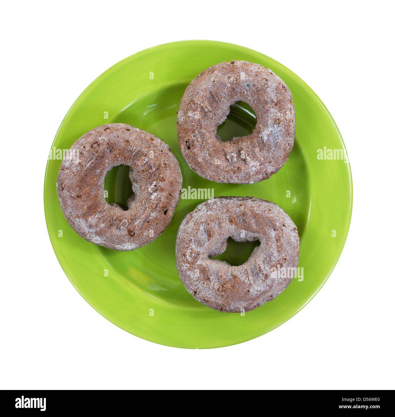 Draufsicht der drei frische Schokoladen Donuts auf einer grünen Platte. Stockfoto
