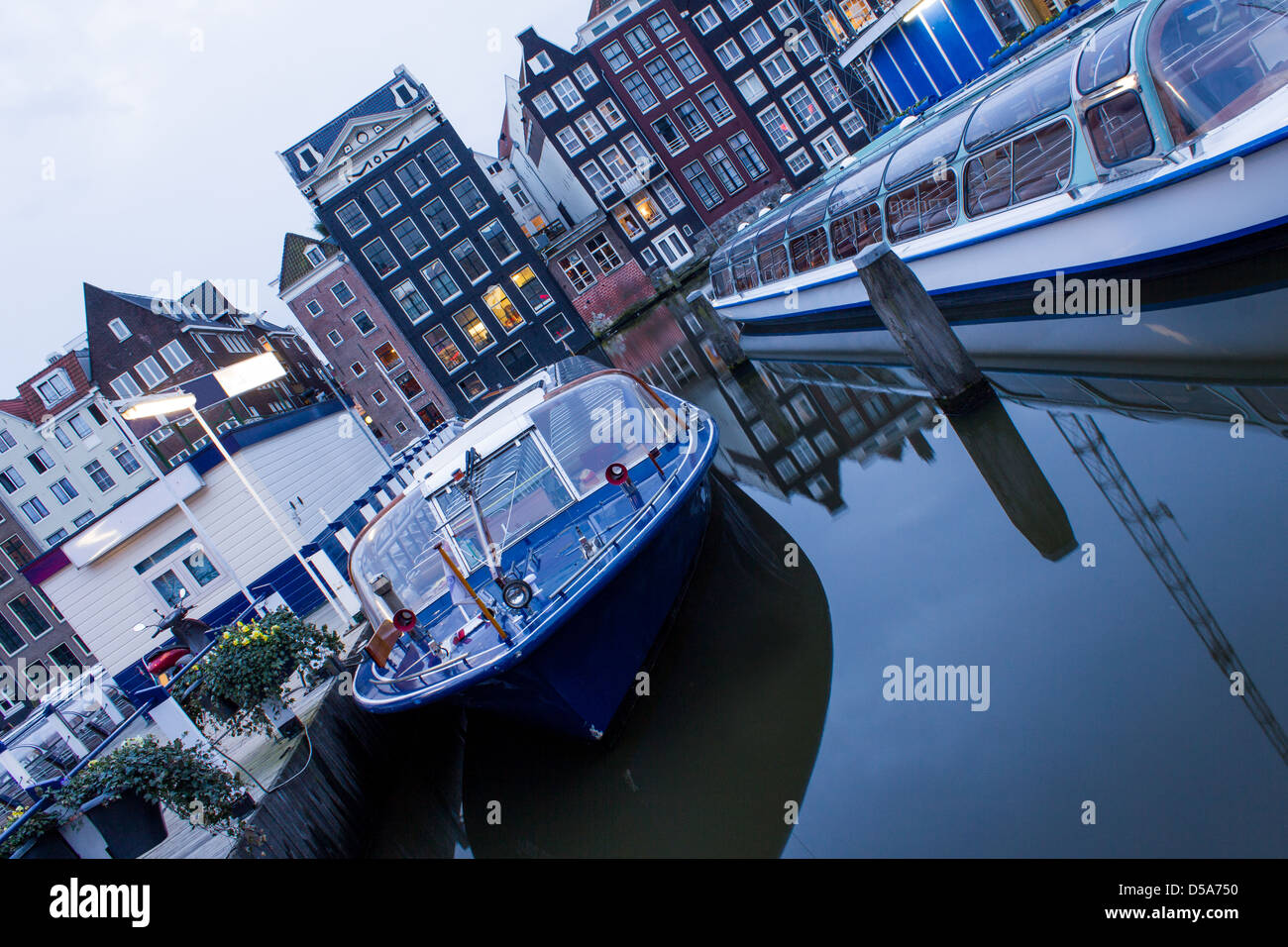 Amsterdamer Gracht am Abend mit touristischen Boote Stockfoto