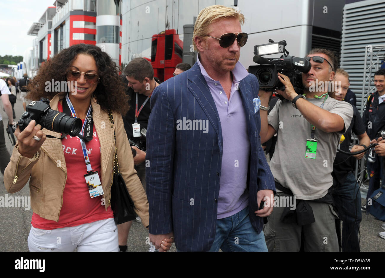 Deutsche Tennis-Legende Boris Becker (R) und seine Frau Lily Spaziergang durch das Fahrerlager im Jahr 2010 Formel 1 Grand Prix von Deutschland am Hockenheimring Rennstrecke in Hockenheim, Deutschland, 25. Juli 2010. Spaniens Alonso von Scuderia Ferrari gewann vor brasilianischer Teamkollege Massa und Deutschlands Vettel von Red Bull Racing. Foto: Ronald Wittek Stockfoto