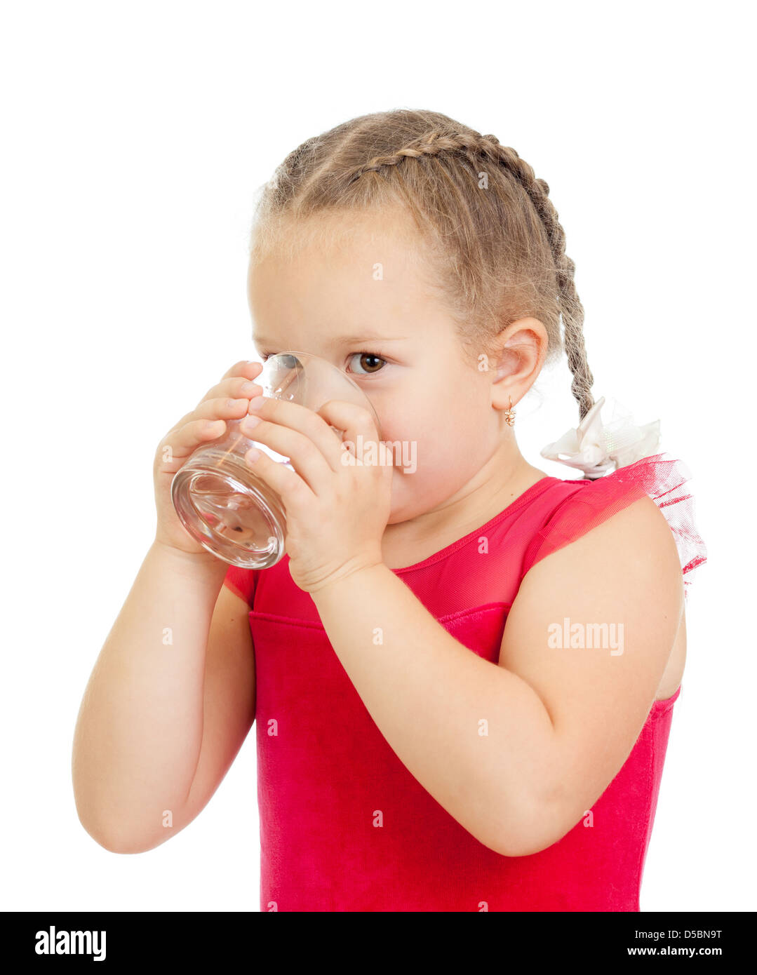 kleine Mädchen Trinkwasser aus Glas auf weißem Hintergrund Stockfoto