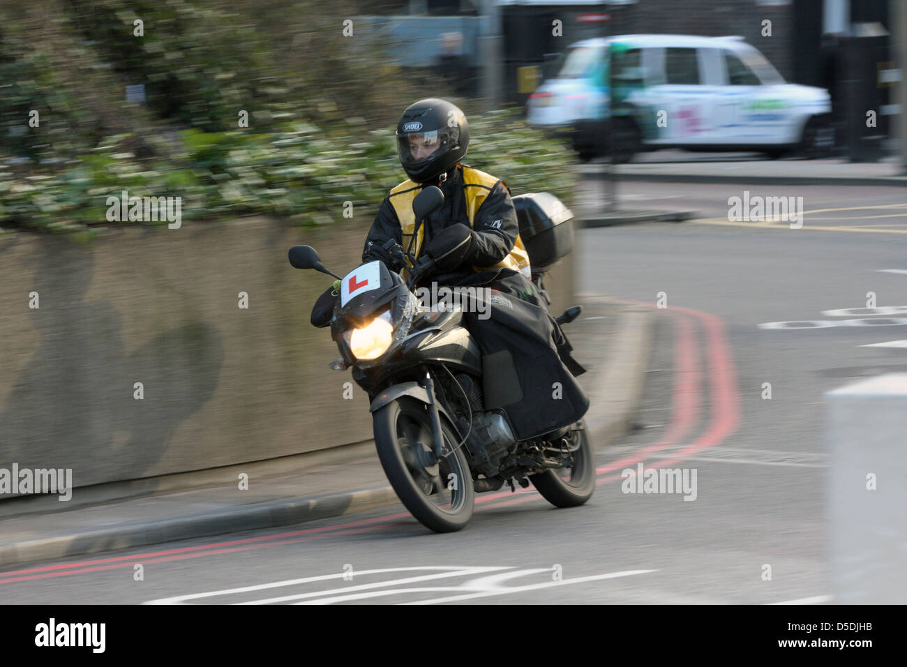 Ein Lernender Motorradfahrer herumfahren einen Kreisverkehr in der Nähe von Waterloo in London, England. Stockfoto