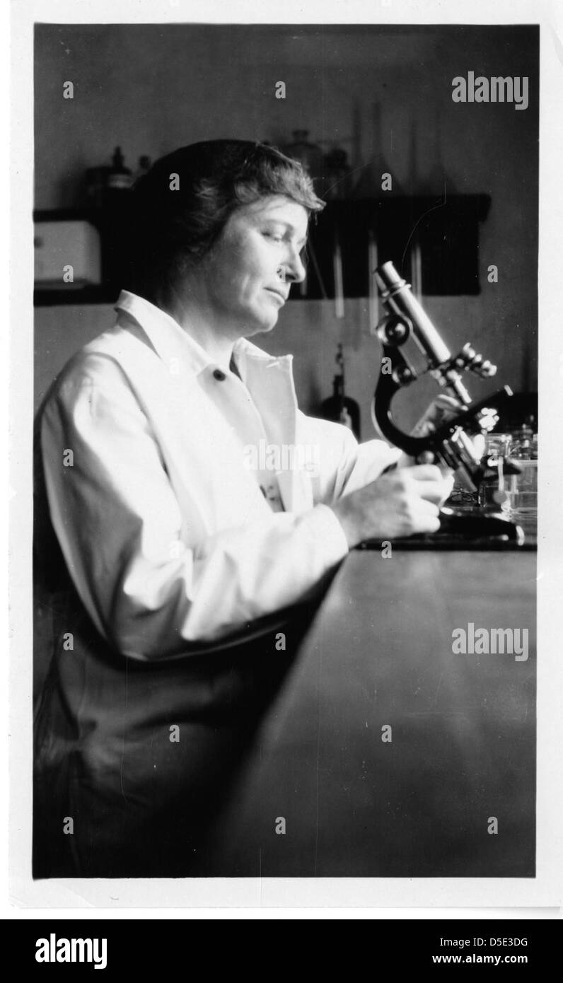 Dieses Foto aus dem Jahr 2011 zeigt Louise Harrison, eine Frau in der Wissenschaft, die mit einem Mikroskop in einem Labormantel sitzt. Sie spiegelt ihren Beitrag zur Forschung und ihre Rolle in der akademischen Welt während des Monats der Frauengeschichte wider. Stockfoto