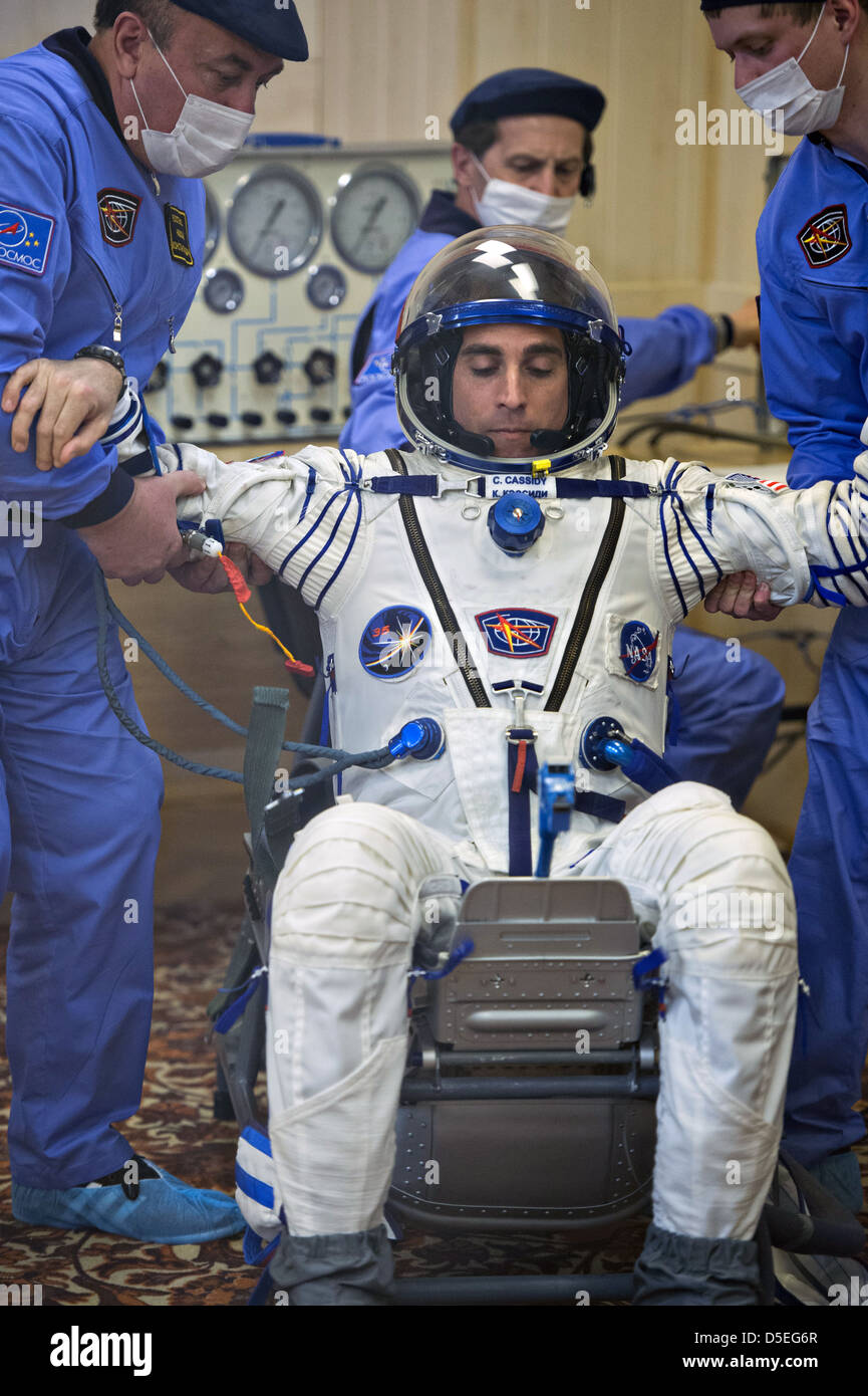 Expedition 35 NASA Flight Engineer Chris Cassidy wird nach Überprüfung seiner russischen Sokol Anzug am Weltraumbahnhof Baikonur 28. März 2013 in Baikonur, Kasachstan Druck aus seinem Stuhl gehoben. Stockfoto