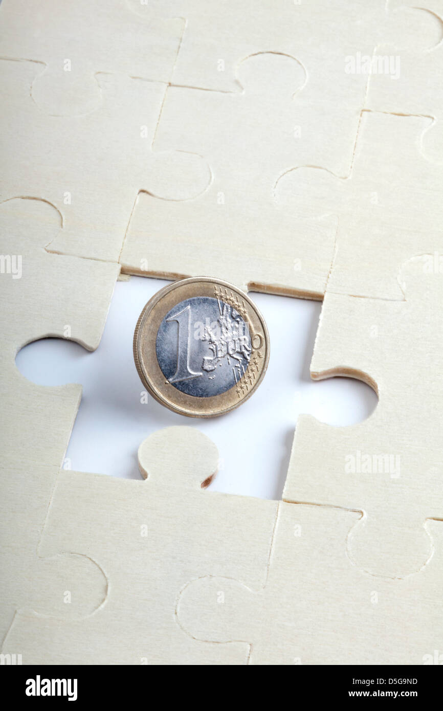 Puzzle mit einem Stück fehlt und 1 Euro Münze Stockfoto