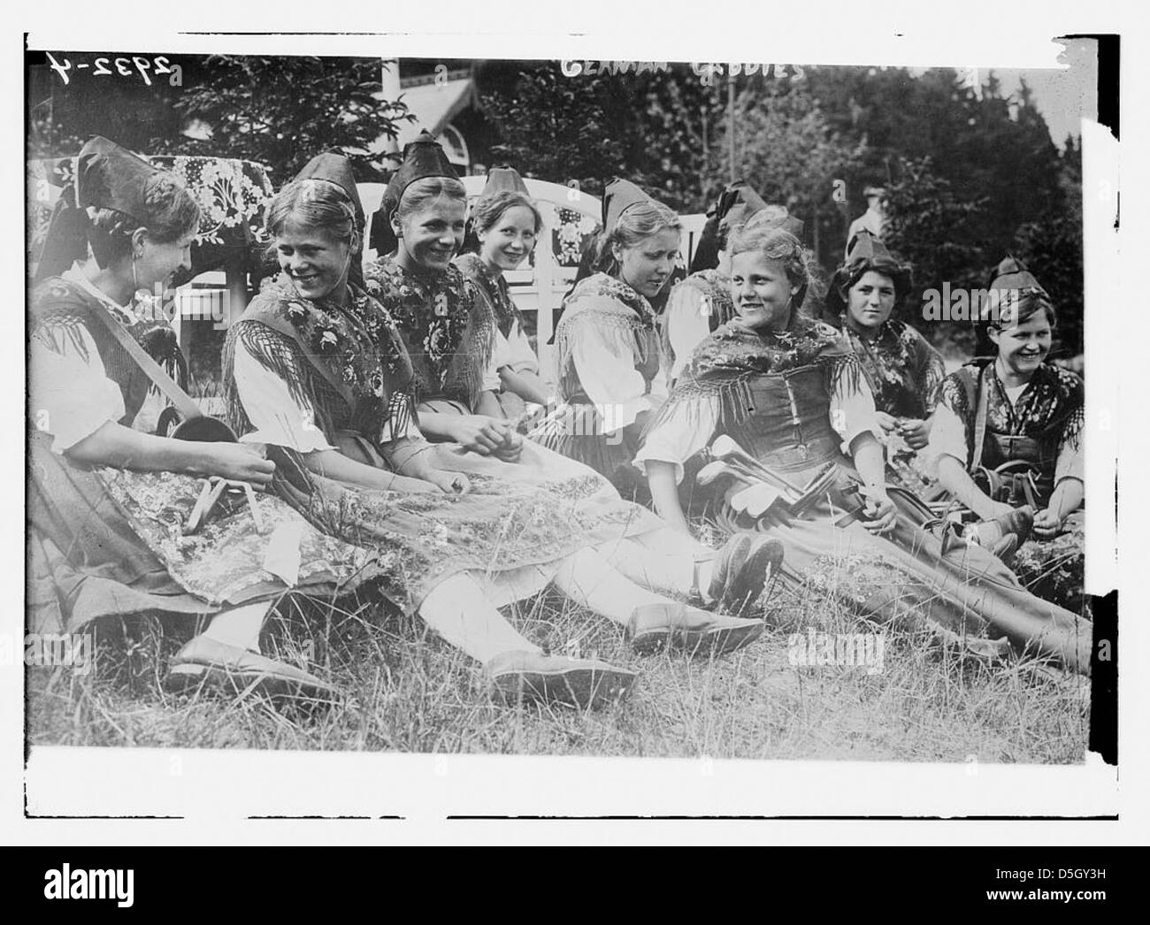 Dieses Foto aus Deutschland zeigt weibliche Caddies in traditionellen Kostümen auf einem Golfplatz. Das Bild spiegelt die kulturellen Aspekte des Golfs im Deutschland des frühen 20. Jahrhunderts wider und zeigt die Kleidung und Rolle der Caddies zu dieser Zeit. Stockfoto