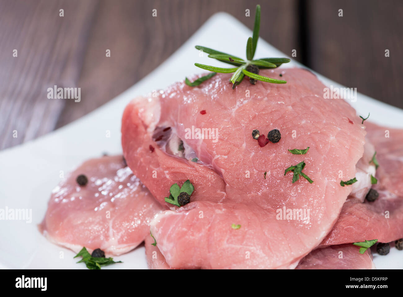 Rohe Schnitzel auf einem Teller (White) Stockfoto