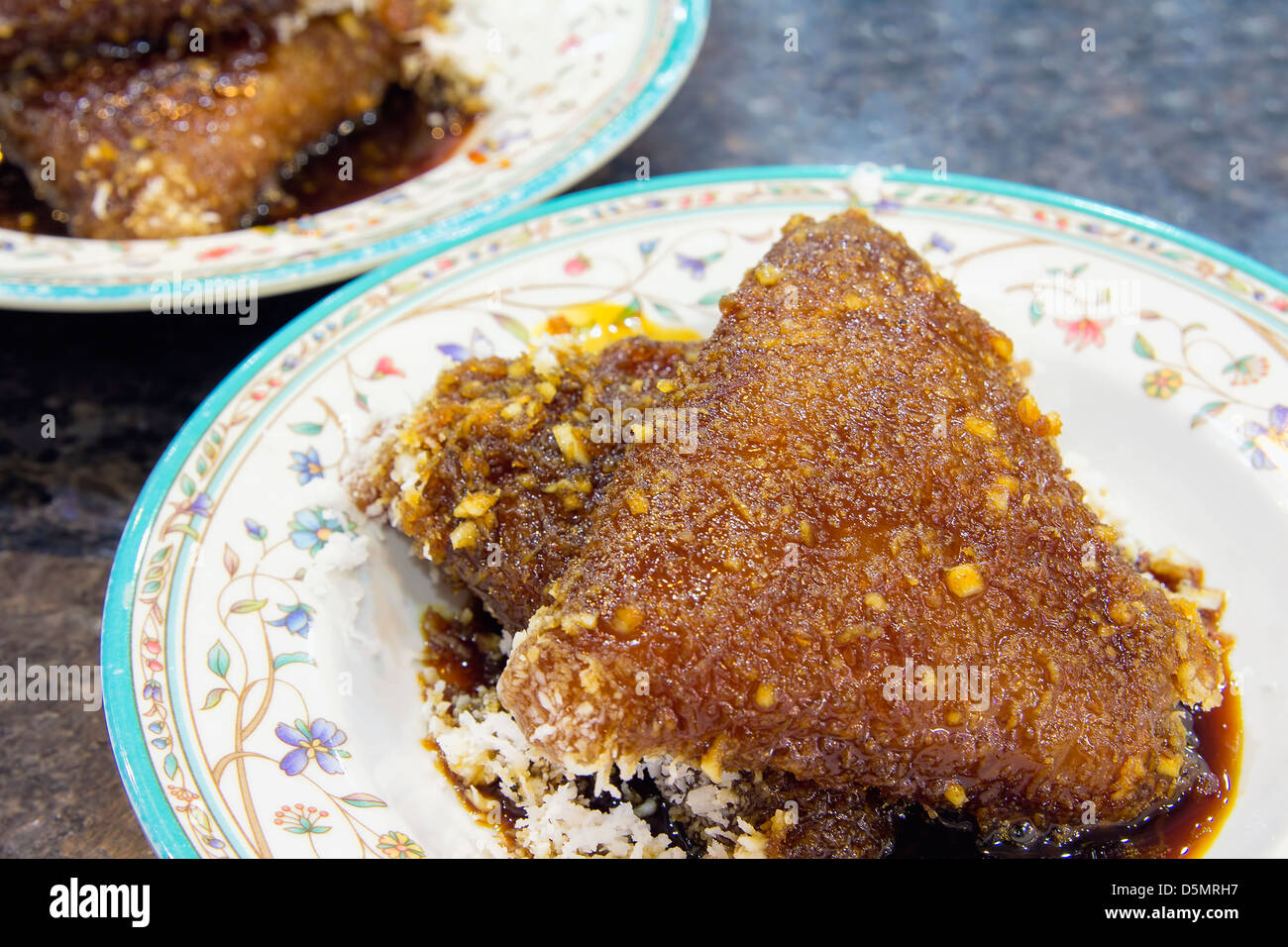 Malaiische Kueh Lopes Klebreis mit Gula Melaka Zuckersirup und Kokosraspeln Dessert Closeup Stockfoto