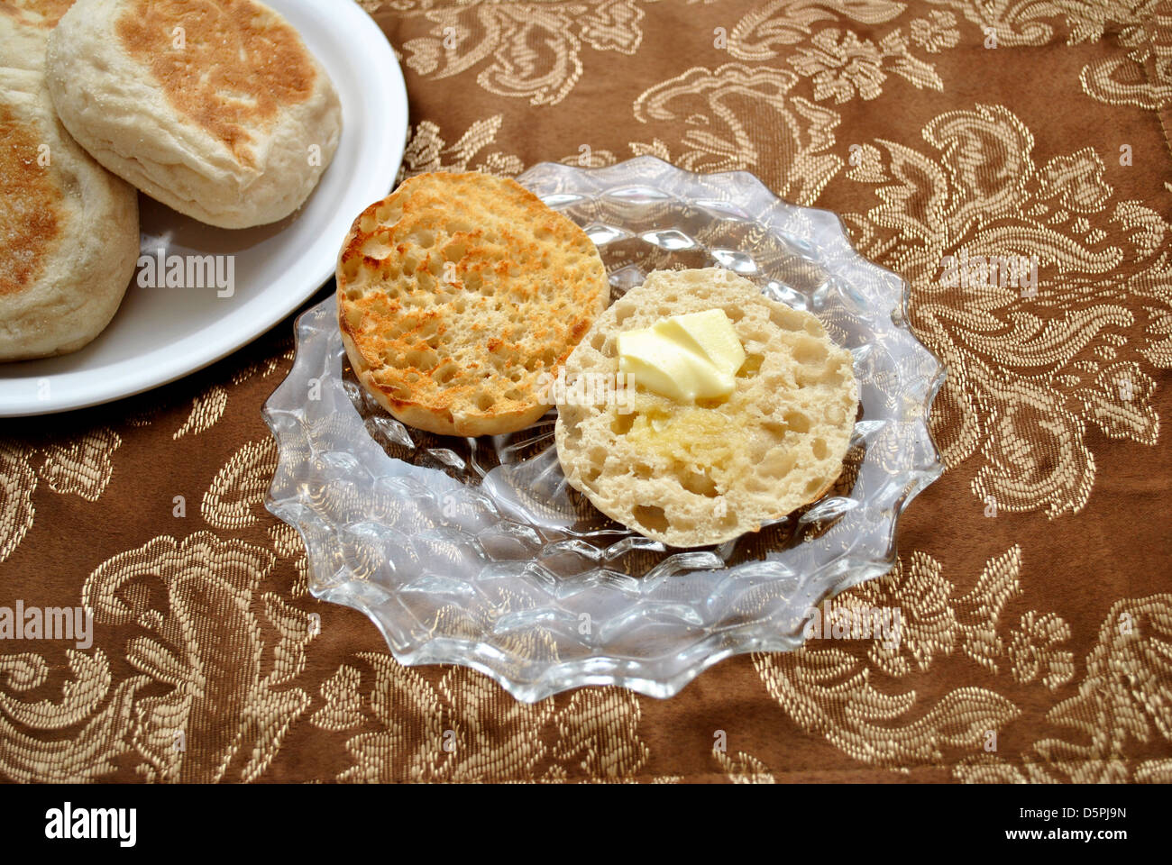 Köstliche englische Muffins mit Butter Stockfoto